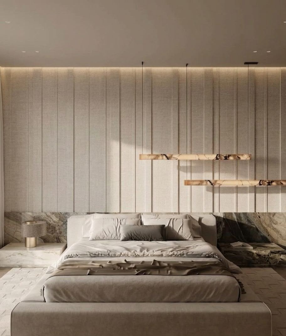 Miagma residential bedroom in Dubai with upholstered bed, pale textured wall panels, marble bedside surfaces and warm architectural lighting