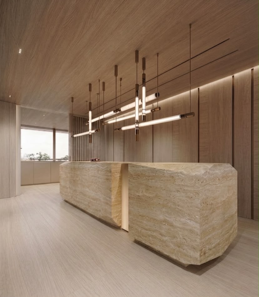 Opus 400 sqm residential interior project in Dubai featuring a sculptural natural stone kitchen island, warm timber wall panels and linear pendant lighting