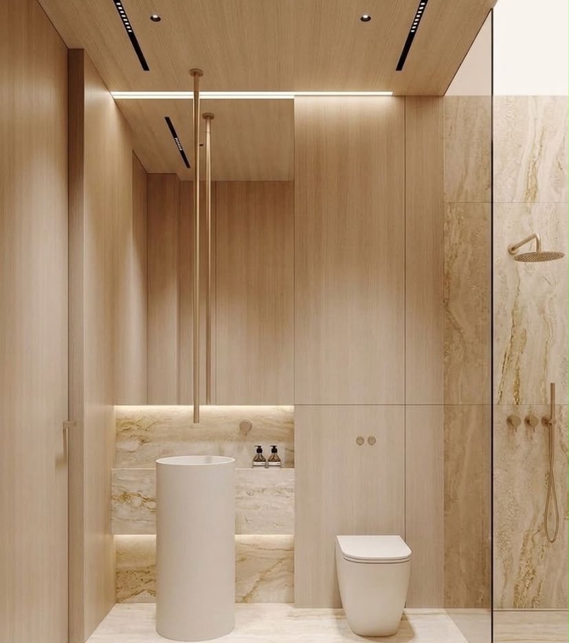 Solara residential bathroom interior in Dubai with timber wall panels, freestanding basin, travertine shower wall and warm integrated lighting