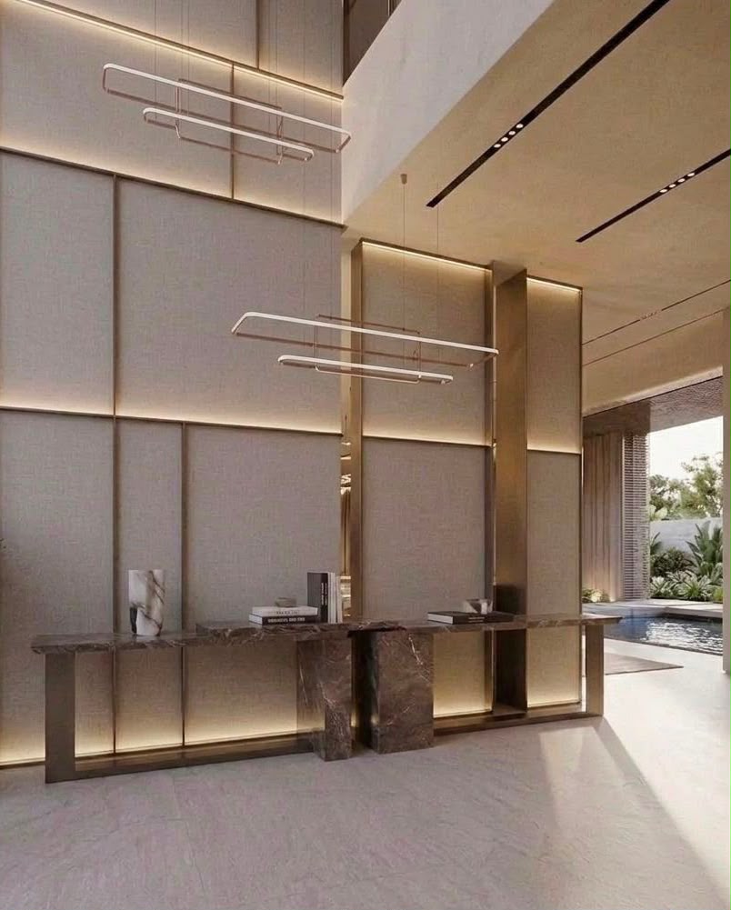 Syrus residential entrance interior in Dubai with double-height wall panels, marble console and suspended linear lighting